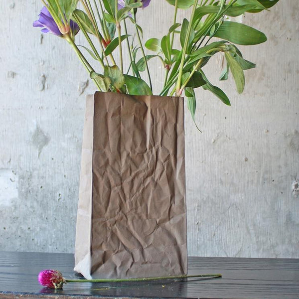 Hand-cast ceramic paper bag vase. This unique vase is a ceramic replica of a brown paper bag. Sandstone, holds water.