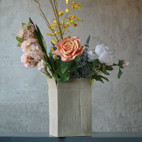 This uniques flower vase is hand cast to resemble a corrugated box with all the details. Use it for fresh or dry flowers. Holds water.
